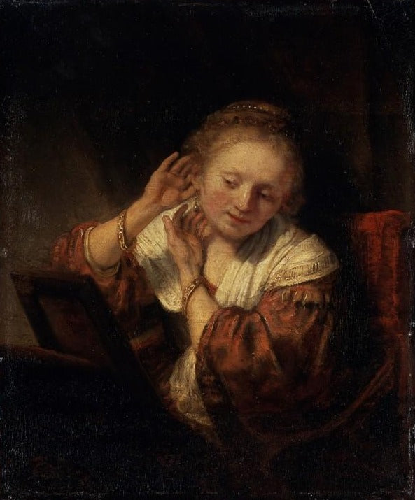 Joven mujer probándose aretes – Rembrandt van Rijn Rembrandt van Rijn mx.artemisreproduction.com